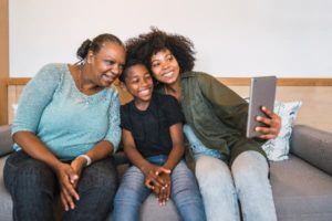 Grandmother sitting with grandson and daughter