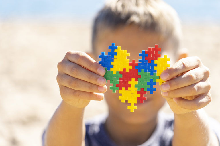 Boy holding puzzle representing autism